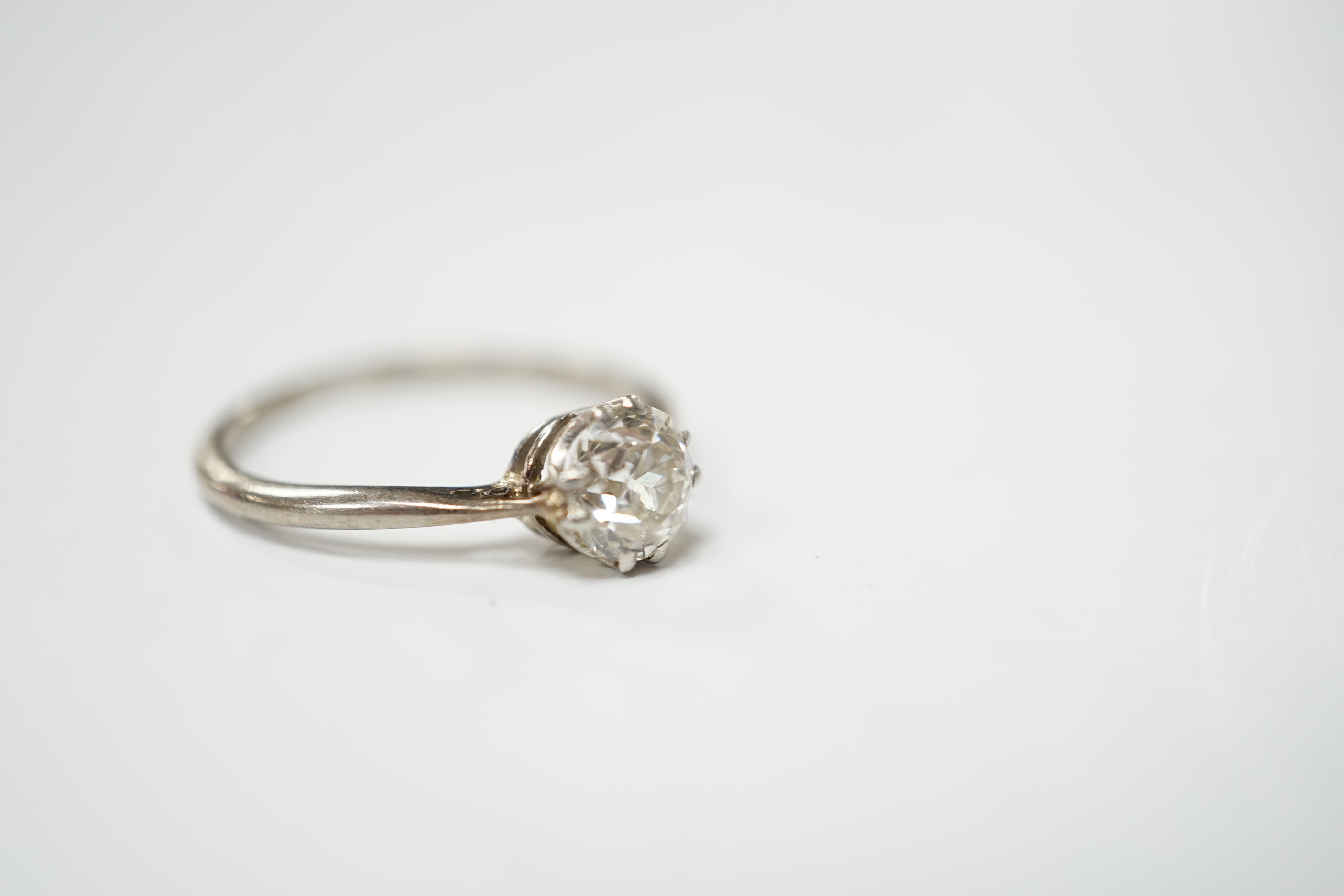 A white metal and solitaire diamond set ring, size O/P, gross weight 2.4 grams
